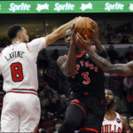 Toronto Raptors' O.G. Anunoby (3) goes up for a shot against Chicago Bulls' DeMar DeRozan (11) and Zach LaVine (8) during the first half of an NBA basketball game Monday, Nov. 7, 2022, in Chicago. (AP Photo/Paul Beaty)