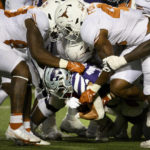 
              Kansas State running back Deuce Vaughn (22) is tackled by Texas defenders during the first half of an NCAA college football game Saturday, Nov. 5, 2022, in Manhattan, Kan. (AP Photo/Reed Hoffmann)
            