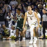 
              Notre Dame's Cormac Ryan (5) celebrates during the first half of the team's NCAA college basketball game against Michigan State on Wednesday, Nov. 30, 2022, in South Bend, Ind. (AP Photo/Michael Caterina)
            