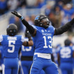 
              Kentucky linebacker J.J. Weaver blows kisses to Louisville fans after getting a stop against Louisville during the first half of an NCAA college football game in Lexington, Ky., Saturday, Nov. 26, 2022. (AP Photo/Michael Clubb)
            