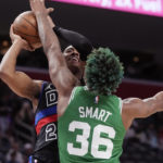 Detroit Pistons guard Jaden Ivey (23) attempts a shot as Boston Celtics guard Marcus Smart (36) defends during the second half of an NBA basketball game, Saturday, Nov. 12, 2022, in Detroit. (AP Photo/Carlos Osorio)