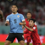 Uruguay's Luis Suarez, left, and South Korea's Kim Moon-hwan vie for the ball during the World Cup group H soccer match between Uruguay and South Korea, at the Education City Stadium in Al Rayyan , Qatar, Thursday, Nov. 24, 2022. (AP Photo/Frank Augstein)