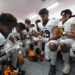 
              Crestwood High School football player Adam Berry (19) leads a muslim prayer before a game in Melvindale, Mich., Friday, Sept. 23, 2022.  (AP Photo/Paul Sancya)
            