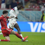 Timothy Weah of the United States, right, scores his side's opening goal during the World Cup, group B soccer match between the United States and Wales, at the Ahmad Bin Ali Stadium in Doha, Qatar, Monday, Nov. 21, 2022. (AP Photo/Ashley Landis)