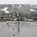 
              A construction worker sweeps ice and debris from an unfinished floor of an affordable housing project in the ski resort town of Vail, Colo., on Oct. 25, 2022. The town offered Vail Resorts access to the 140-bed apartment complex instead of building workforce housing on a company-owned plot nearby. The resort has not accepted that deal, saying the city shouldn't be offering either-or propositions, but rather, trying to work with the resort to add as many affordable housing units as it can. (AP Photo/Thomas Peipert)
            