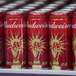 Budweiser cans are lined up in a cooler at the World Cup media center at the Qatar National Convention Center, in Sunday, Nov. 20, 2022. World Cup organizers have banned the sale of all beer with alcohol at the eight stadiums used for the soccer tournament. (AP Photo/Ashley Landis)