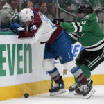 Colorado Avalanche right wing Logan O'Connor (25) and Dallas Stars defenseman Nils Lundkvist (5) compete for control of the puck up against the boards in the second period of an NHL hockey game Monday, Nov. 21, 2022, in Dallas. (AP Photo/Tony Gutierrez)
