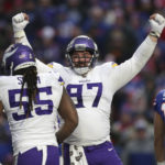 Minnesota Vikings defensive tackle Harrison Phillips (97) celebrates with linebacker Za'Darius Smith (55) as the Vikings take the lead over the Buffalo Bills in the second half of an NFL football game, Sunday, Nov. 13, 2022, in Orchard Park, N.Y. (AP Photo/Joshua Bessex)