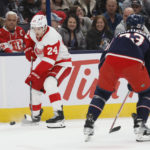 
              Detroit Red Wings' Pius Suter, left, looks for an open pass as Columbus Blue Jackets' Jake Christiansen defends during the first period of an NHL hockey game, Saturday, Nov. 19, 2022, in Columbus, Ohio. (AP Photo/Jay LaPrete)
            