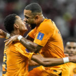 
              Cody Gakpo of the Netherlands, left, celebrates after scoring his side's opening goal during the World Cup group A soccer match between the Netherlands and Qatar, at the Al Bayt Stadium in Al Khor , Qatar, Tuesday, Nov. 29, 2022. (AP Photo/Moises Castillo)
            