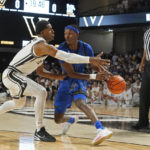 
              Memphis guard Keonte Kennedy, center, is defended by Vanderbilt's Jordan Wright, left, in the first half of an NCAA college basketball game Monday, Nov. 7, 2022, in Nashville, Tenn. (AP Photo/Mark Humphrey)
            