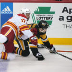 Calgary Flames' Milan Lucic (17) can Pittsburgh Penguins' Josh Archibald collide during the first period of an NHL hockey game in Pittsburgh, Wednesday, Nov. 23, 2022. (AP Photo/Gene J. Puskar)