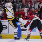 
              Pittsburgh Penguins center Evgeni Malkin, left, is checked by Chicago Blackhawks center Colin Blackwell during the first period of an NHL hockey game in Chicago, Sunday, Nov. 20, 2022. (AP Photo/Nam Y. Huh)
            