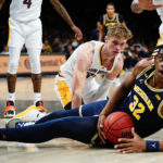 Michigan's Tarris Reed Jr. (32) looks to pass away from Arizona State's Duke Brennan (24) during the first half of an NCAA college basketball game in the championship round of the Legends Classic Thursday, Nov. 17, 2022, in New York. (AP Photo/Frank Franklin II)