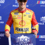 
              Joey Logano poses for the media after winning the pole for a NASCAR Cup Series auto race Saturday, Nov. 5, 2022, in Avondale, Ariz. The race is for the championship on Sunday. (AP Photo/Rick Scuteri)
            
