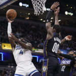 
              Minnesota Timberwolves guard Jaylen Nowell (4) shoots in front of Indiana Pacers guard Bennedict Mathurin (00) during the first half of an NBA basketball game in Indianapolis, Wednesday, Nov. 23, 2022. (AP Photo/AJ Mast)
            