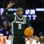 
              Michigan State's Tre Holloman calls a play during the first half of the team's NCAA college basketball game against Notre Dame on Wednesday, Nov. 30, 2022, in South Bend, Ind. (AP Photo/Michael Caterina)
            