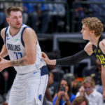 Dallas Mavericks point guard Luka Doncic. (77) is defended by Utah Jazz forward Lauri Markkanen during the first half of an NBA basketball game Wednesday, Nov. 2, 2022, in Dallas. (AP Photo/Gareth Patterson)