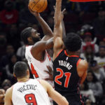 Chicago Bulls' Patrick Williams (44) goes up for a shot against Toronto Raptors' Thaddeus Young (21) during the first half of an NBA basketball game Monday, Nov. 7, 2022, in Chicago. (AP Photo/Paul Beaty)