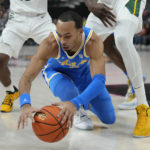UCLA's Amari Bailey (5) scrambles for the ball against Baylor during the first half of an NCAA college basketball game Sunday, Nov. 20, 2022, in Las Vegas. (AP Photo/John Locher)