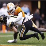 Missouri wide receiver Barrett Banister (11) is tackled by Tennessee defensive back Tamarion McDonald (12) during the second half of an NCAA college football game Saturday, Nov. 12, 2022, in Knoxville, Tenn. (AP Photo/Wade Payne)
