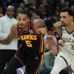 Atlanta Hawks' Dejounte Murray drives past Milwaukee Bucks' George Hill during the first half of an NBA basketball game Monday, Nov. 14, 2022, in Milwaukee. (AP Photo/Morry Gash)