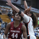 Stanford forward Kiki Iriafen (44) drives to the basket while defended by Pacific center Elizabeth Elliott, right, during the second half of an NCAA college basketball game in Stockton, Calif., Friday, Nov. 11, 2022. (AP Photo/Godofredo A. Vásquez)