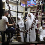 
              FILE - Customers browse for "agal", a double cord headband, at a shop before the holy month of Ramadan in Doha, Qatar, Saturday, May 4, 2019.Qatar has sought to portray itself as welcoming foreigners to this hereditarily ruled emirate, where traditional Muslim values remain strong.(AP Photo/Kamran Jebreili, File)
            