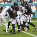 
              Houston Texans running back Dare Ogunbowale (33) scores a touchdown during the second half of an NFL football game against the Miami Dolphins, Sunday, Nov. 27, 2022, in Miami Gardens, Fla. (AP Photo/Michael Laughlin)
            