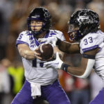 
              TCU quarterback Max Duggan (15) hands off to running back Kendre Miller (33) during the second half of the team's NCAA college football game against Texas on Saturday, Nov. 12, 2022, in Austin, Texas. (AP Photo/Stephen Spillman)
            