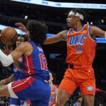 
              Detroit Pistons forward Isaiah Livers (12) grabs a rebound away from Oklahoma City Thunder forward Ousmane Dieng (13) during the first half of an NBA basketball game, Monday, Nov. 7, 2022, in Detroit. (AP Photo/Carlos Osorio)
            
