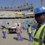 
              FILE - Laborers walk to the Lusail Stadium, one of the 2022 World Cup stadiums, in Lusail, Qatar, Friday, Dec. 20, 2019. With just days to go before Qatar hosts the World Cup, rights groups fear that a window for addressing the widespread exploitation of foreign workers could soon close. (AP Photo/Hassan Ammar, File)
            