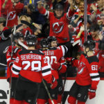 New Jersey Devils center Jack Hughes celebrates with left wing Tomas Tatar (90) after scoring a goal against the Arizona Coyotes during the first period of an NHL hockey game, Saturday, Nov. 12, 2022, in Newark, N.J. (AP Photo/Noah K. Murray)
