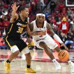 
              Louisville guard El Ellis (3) attempts to get past Appalachian State guard Tyree Boykin (30) during the second half of an NCAA college basketball game in Louisville, Ky., Tuesday, Nov. 15, 2022. Appalachian St. won 61-60. (AP Photo/Timothy D. Easley)
            