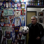 
              Osvaldo Santander holds a soccer ball in a room at his home during an interview with The Associated Press, in Buenos Aires, Argentina, Thursday, Aug. 18, 2022. Santander and his son Julian will travel to Qatar for the World Cup, their third World Cup as fans. (AP Photo/Natacha Pisarenko)
            