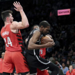 
              Brooklyn Nets forward Kevin Durant (7) maintains possession of the ball as Portland Trail Blazers forward Drew Eubanks (24) defends during the first half of an NBA basketball game, Sunday, Nov. 27, 2022, in New York. (AP Photo/Jessie Alcheh)
            