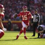 
              Kansas City Chiefs quarterback Patrick Mahomes runs as he throws as touchdown pass to wide receiver Marquez Valdes-Scantling during the first half of an NFL football game against the Jacksonville Jaguars Sunday, Nov. 13, 2022, in Kansas City, Mo. (AP Photo/Charlie Riedel)
            