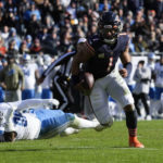 
              Chicago Bears quarterback Justin Fields (1) runs for a one-yard touchdown after escaping Detroit Lions defensive end Isaiah Buggs (96) during the first half of an NFL football game in Chicago, Sunday, Nov. 13, 2022. (AP Photo/Nam Y. Huh)
            