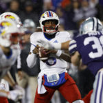 Kansas quarterback Jalon Daniels (6) looks for a receiver during the second quarter of the team's NCAA college football game against Kansas State on Saturday, Nov. 26, 2022, in Manhattan, Kan. (AP Photo/Colin E. Braley)