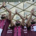 Fans of Qatar cheer as they wait for the start of a World Cup group A soccer match between Qatar and Senegal, at the Al Thumama Stadium in Doha, Qatar, Friday, Nov. 25, 2022. (AP Photo/Darko Bandic)