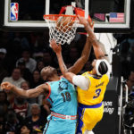 Phoenix Suns' Bismack Biyombo (18) gets dunked on by Los Angeles Lakers' Anthony Davis (3) during the second half of an NBA basketball game in Phoenix, Tuesday, Nov. 22, 2022. The Phoenix Suns won the game 115-105. (AP Photo/Darryl Webb)