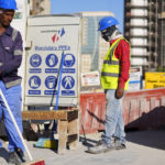 
              Construction cite's workers wait for trucks at a construction cite in Lusail downtown, Qatar, Thursday, Nov. 24, 2022. (AP Photo/Pavel Golovkin)
            