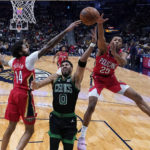 Boston Celtics forward Jayson Tatum (0) goes to the basket against New Orleans Pelicans forward Brandon Ingram (14) and guard Trey Murphy III (25) in the first half of an NBA basketball game in New Orleans, Friday, Nov. 18, 2022. (AP Photo/Gerald Herbert)