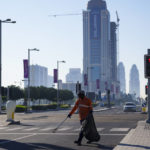 
              A municipal worker walks in a street in Lusail downtown, Qatar, Thursday, Nov. 24, 2022. (AP Photo/Pavel Golovkin)
            