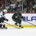
              Minnesota Wild defenseman Jake Middleton (5) controls the puck against Arizona Coyotes defenseman J.J. Moser (90) during the first period of an NHL hockey game Sunday, Nov. 27, 2022, in St. Paul, Minn. (AP Photo/Stacy Bengs)
            