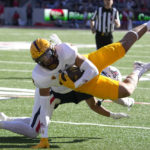 Arizona linebacker Sterling Lane II upends Arizona State tight end Jalin Conyers (12) in the first half during an NCAA college football game, Friday, Nov. 25, 2022, in Tucson, Ariz. (AP Photo/Rick Scuteri)