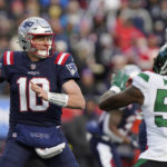 
              New England Patriots quarterback Mac Jones (10) looks to pass while pressured by New York Jets linebacker Quincy Williams (56) during the first half of an NFL football game, Sunday, Nov. 20, 2022, in Foxborough, Mass. (AP Photo/Steven Senne)
            