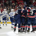 Members of the Washington Capitals celebrate left wing Sonny Milano's goal in the third period of an NHL hockey game against the Tampa Bay Lightning, Friday, Nov. 11, 2022, in Washington. Washington won 5-1. (AP Photo/Patrick Semansky)