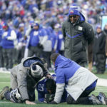 New York Giants cornerback Jason Pinnock (27) kneels on the field after an apparent injury during the second half of an NFL football game against the Detroit Lions, Sunday, Nov. 20, 2022, in East Rutherford, N.J. (AP Photo/Seth Wenig)