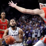 
              Kansas State guard Markquis Nowell (1) looks to shoot under pressure from Texas-Rio Grande Valley forward Dima Zdor (10) during the first half of an NCAA college basketball game Monday, Nov. 7, 2022, in Manhattan, Kan. (AP Photo/Charlie Riedel)
            